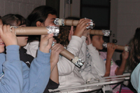Girls in a classroom look through their spectroscopes