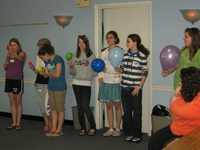 Girls line up with balloons representing different types of stars