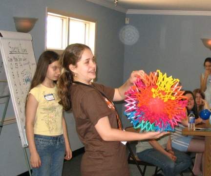 Picture of a Girl Scout helping to demonstrate what happens in a supernova explosion, as described in the activities section of this web site