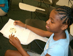 Picture of a Girl Scout finding the abundance of her cosmic trail mix, as described in the activities section of this web site
