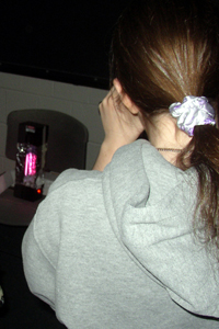 Girl views an element light source with her spectroscope
