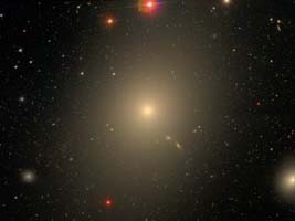 M 87, an elliptical that appears nearly circular and is classified as an E0 galaxy in the Hubble classification scheme.