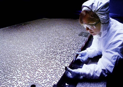 Photo of an engineer working on the coded aperture mask used for the Burst Alert Telescope on Swift